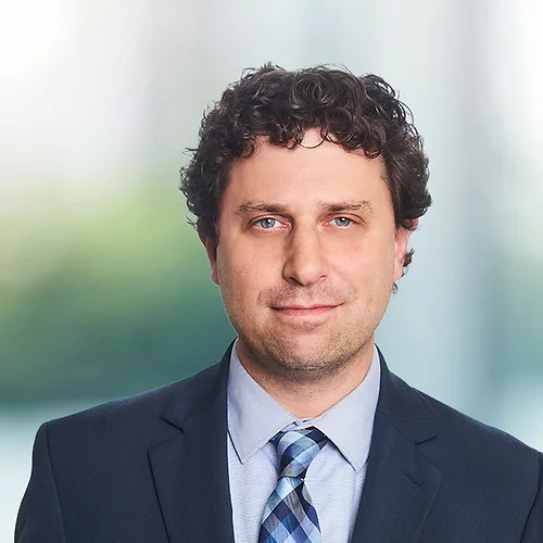 A photo of attorney Adam Yanoff against a softly blurred office background