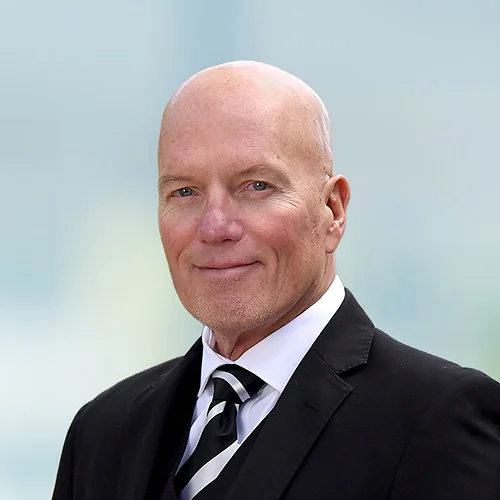 A photo of attorney Stan Blyth against a softly blurred office background
