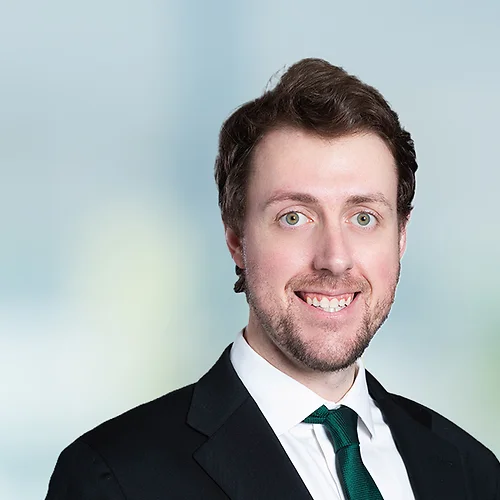 A photo of attorney Mason Englet against a softly blurred office background