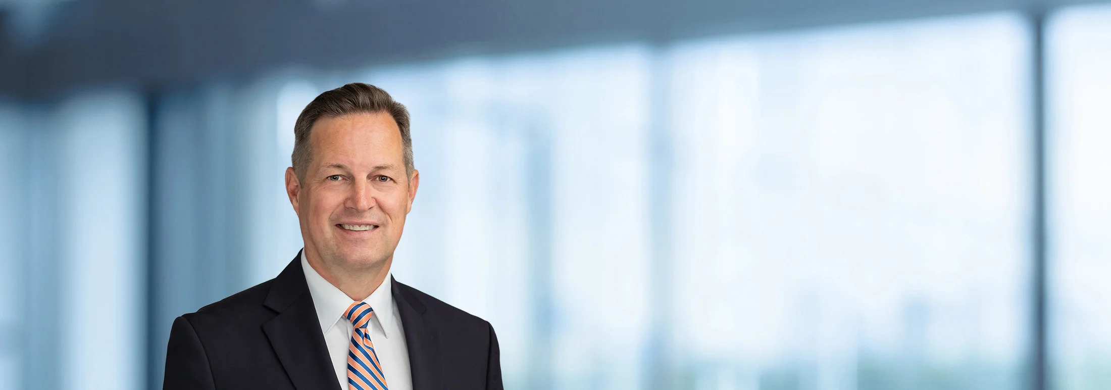 A photo of attorney, Thomas Eastmond, against a softly blurred office background