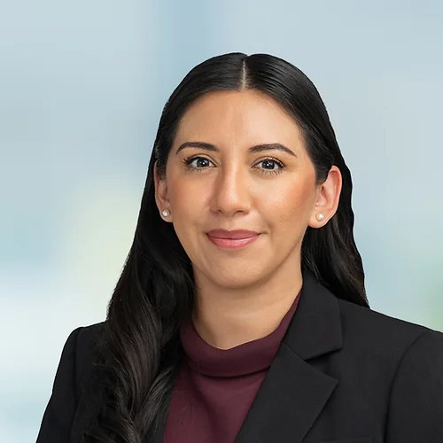 A photo of attorney Angelica Sanchez against a softly blurred office background