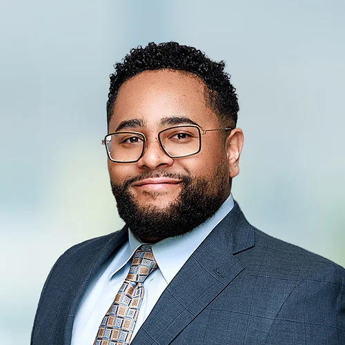 A photo of attorney Caleb Lewis against a softly blurred office background