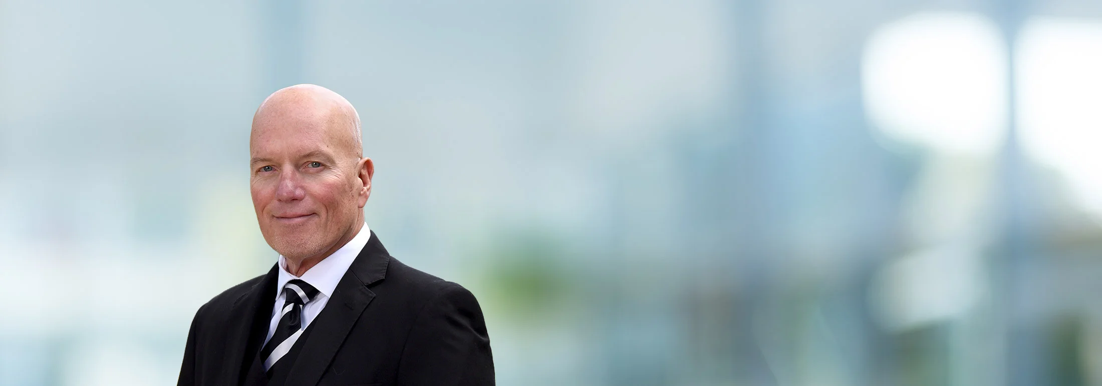 A photo of attorney Stan Blyth against a softly blurred office background