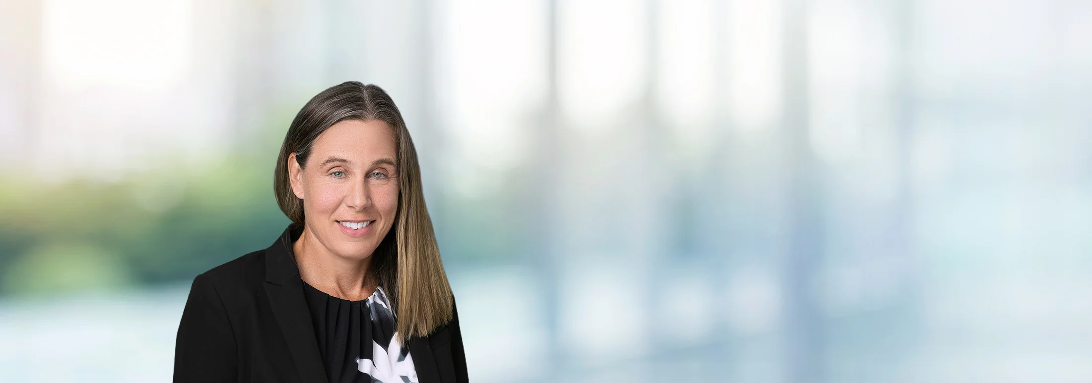 A photo of attorney, Katie Jones, against a softly blurred office background.