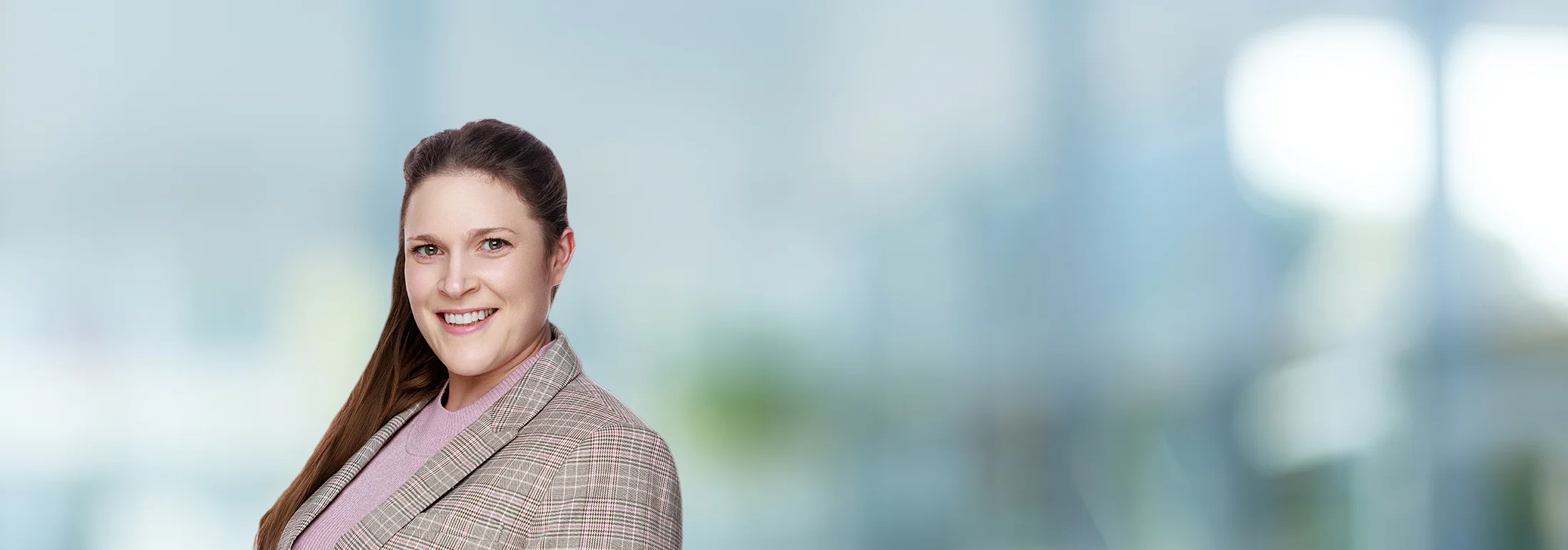 A photo of attorney, Madeleine King, against a softly blurred office background.
