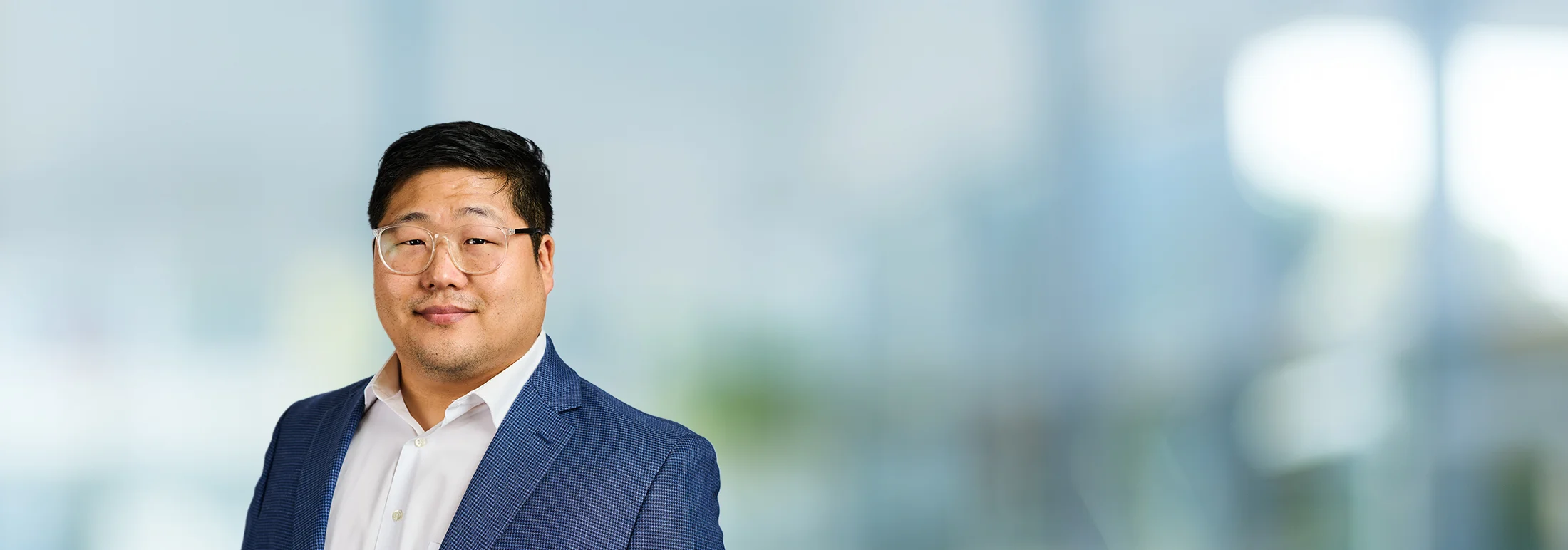 A photo of attorney Peter Lee against a softly blurred office background