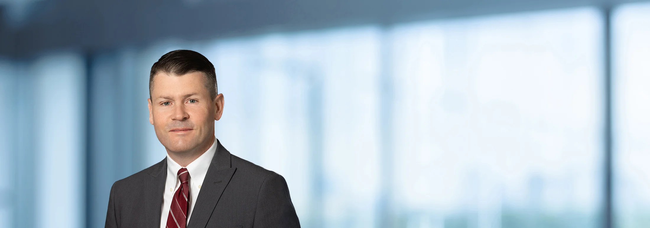 A photo of attorney Aaron Hayes against a softly blurred office background