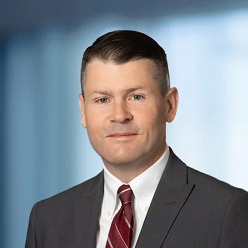 A photo of attorney Aaron Hayes against a softly blurred office background