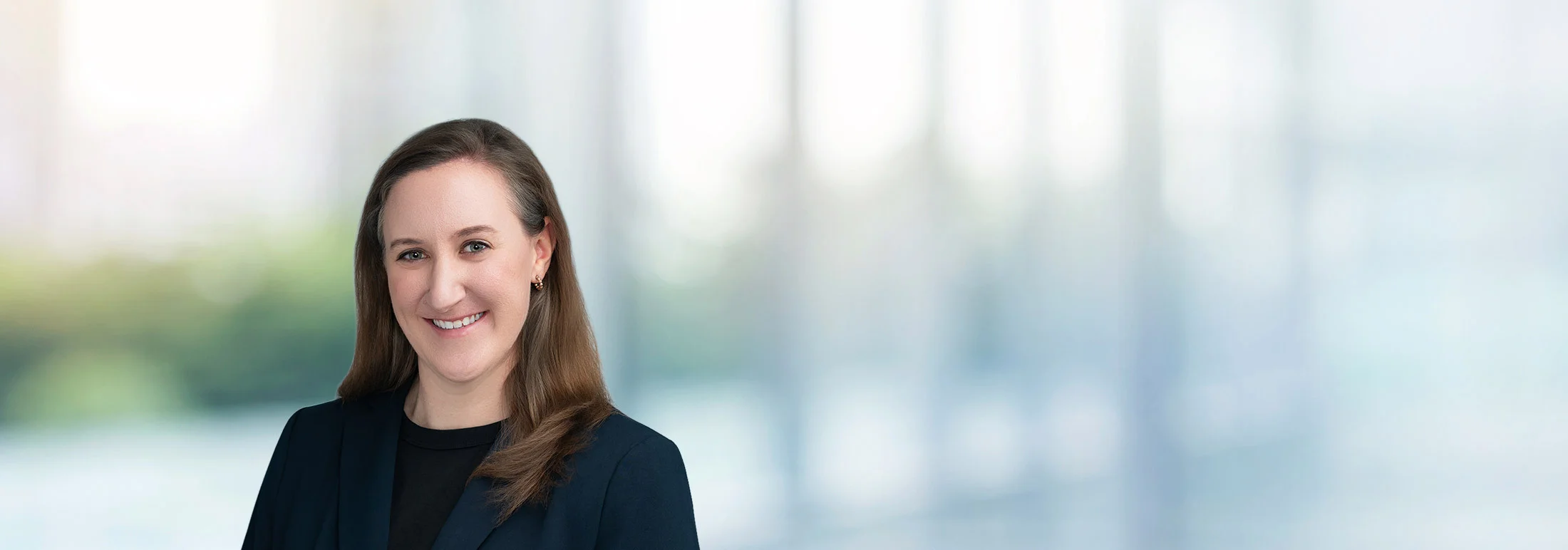 A photo of attorney Laura Free against a softly blurred office background