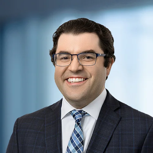 A photo of attorney, Brian Martinez, against a softly blurred office background.