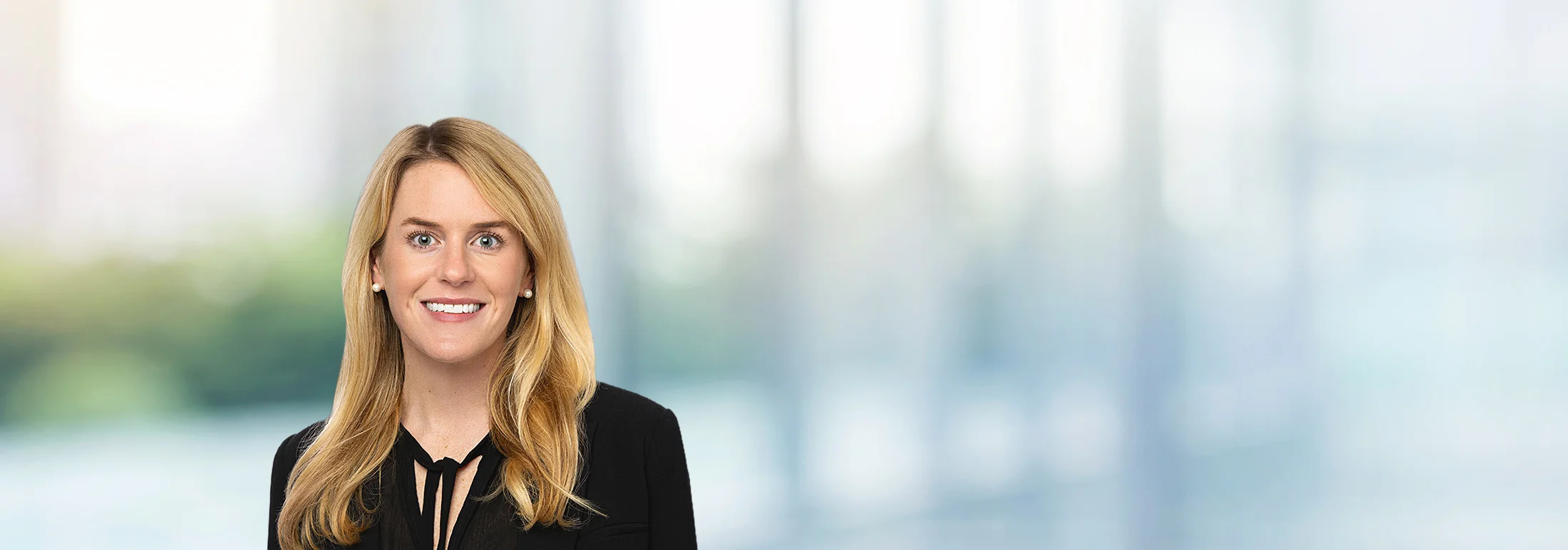 A photo of attorney, Lea McBryde, against a softly blurred office background.