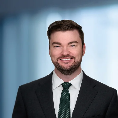 A photo of attorney Alden Butier against a softly blurred office background