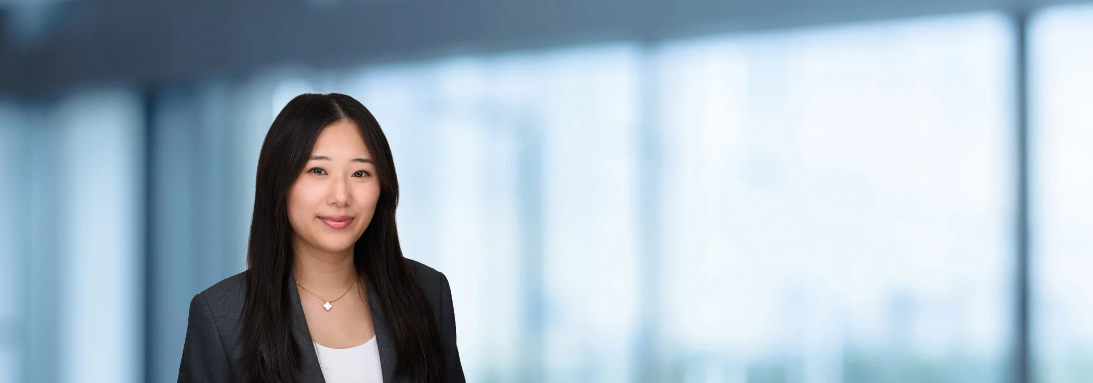 A photo of attorney Yuhan Jia against a softly blurred office background