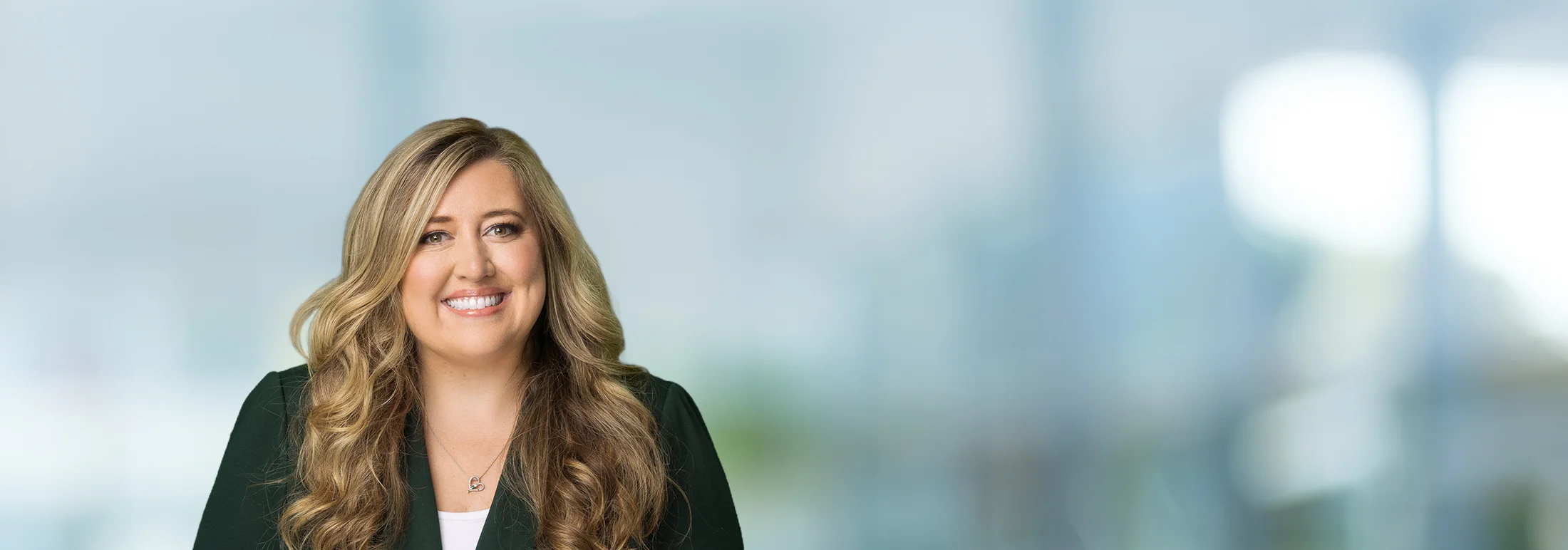 A photo of attorney, Rachel Mineo, against a softly blurred office background.