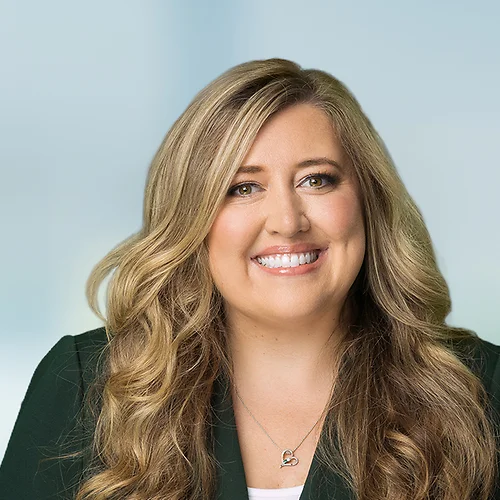 A photo of attorney, Rachel Mineo, against a softly blurred office background.
