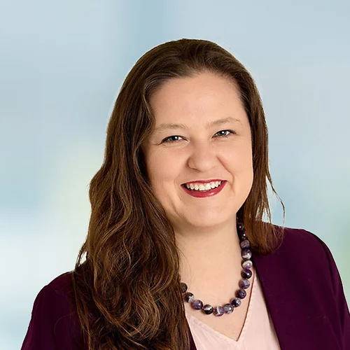 A photo of attorney Breanne Patton against a softly blurred office background