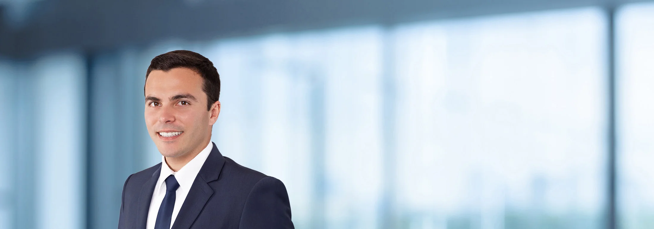 A photo of attorney Kyle Greenway against a softly blurred office background