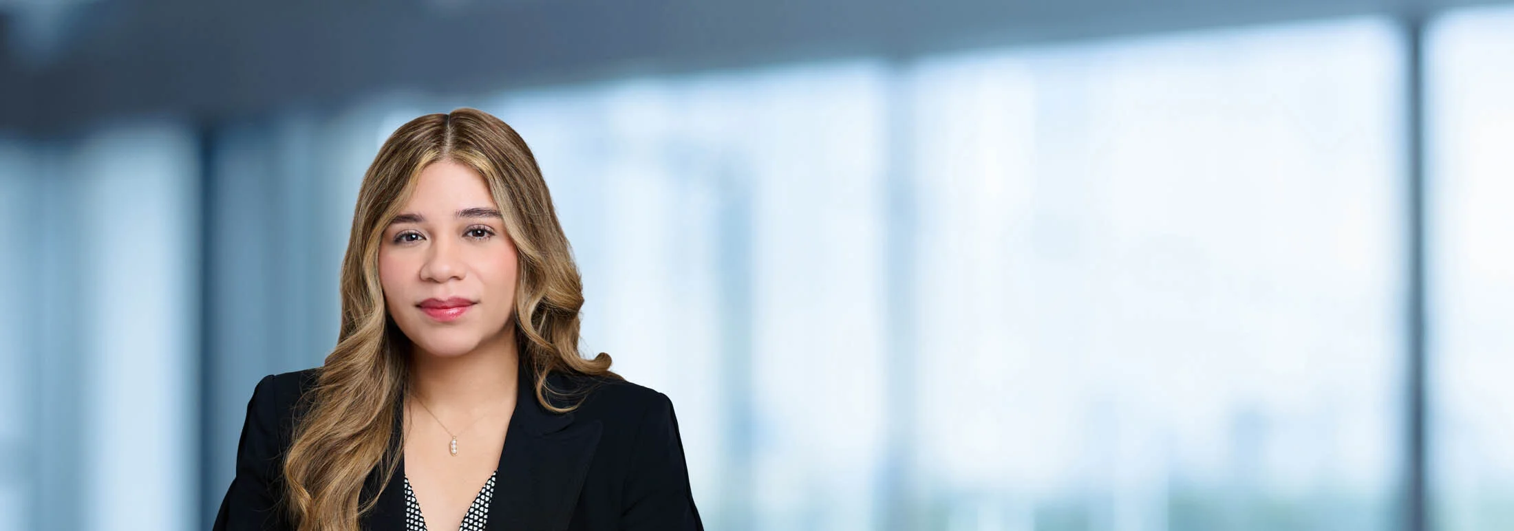 A photo of attorney Brianna Morales against a softly blurred office background