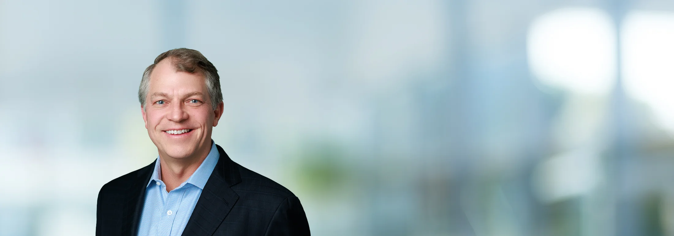 A photo of attorney, Dan Nolan, against a softly blurred office background.