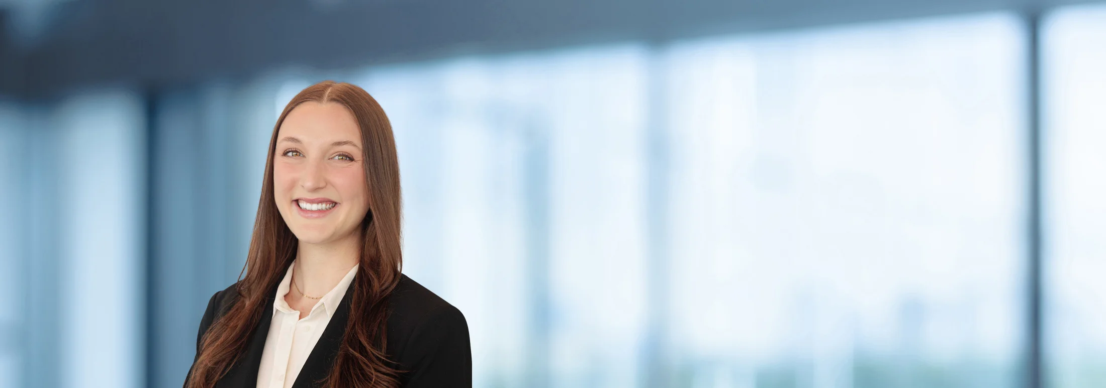 A photo of attorney Carly Schwamm against a softly blurred office background