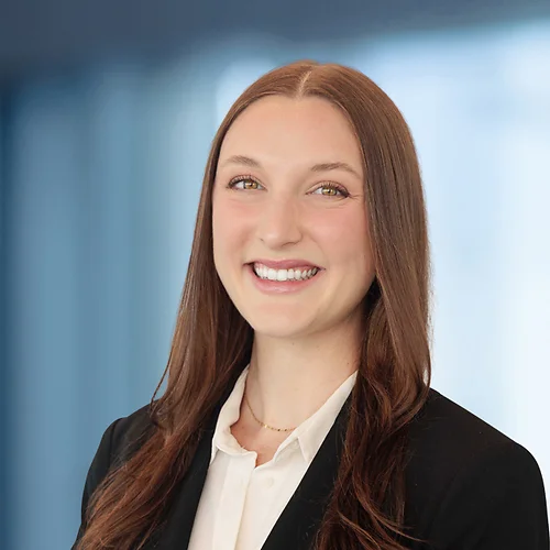A photo of attorney Carly Schwamm against a softly blurred office background