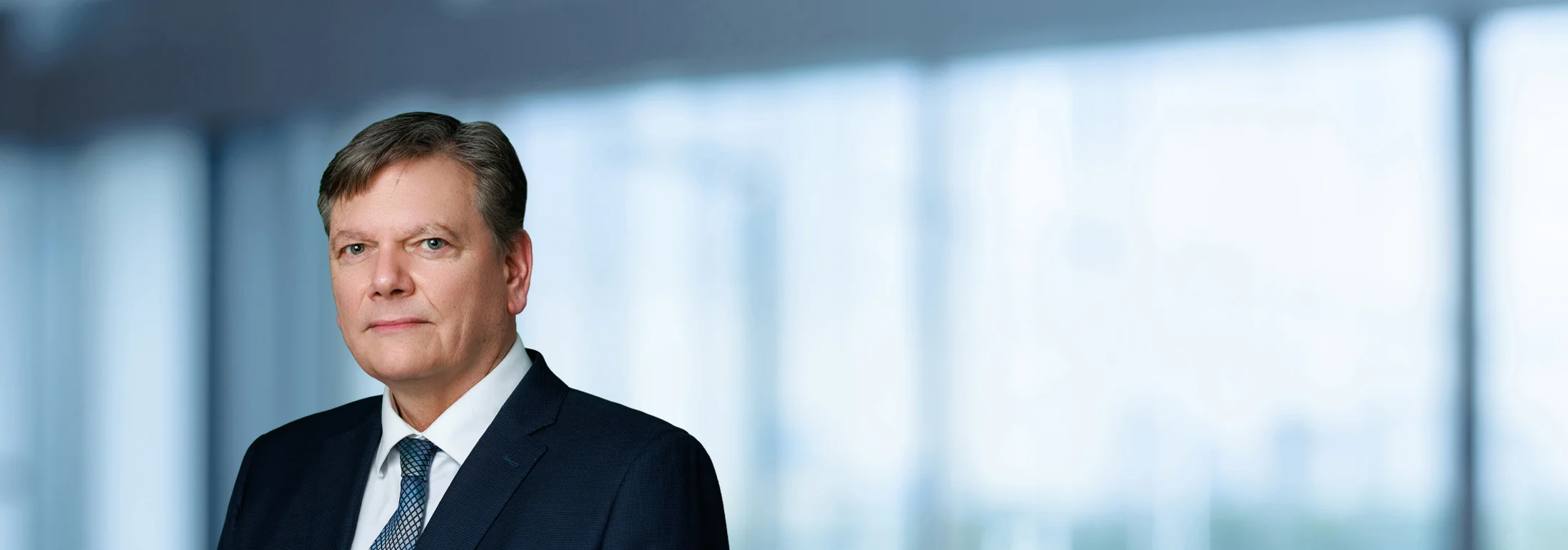 A photo of attorney, Jamie Palfai, against a softly blurred office background.