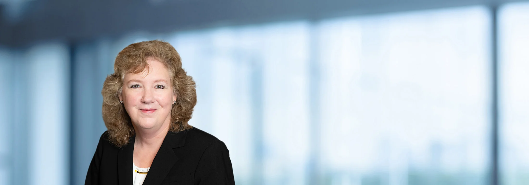 A photo of attorney Mary Melton against a softly blurred office background