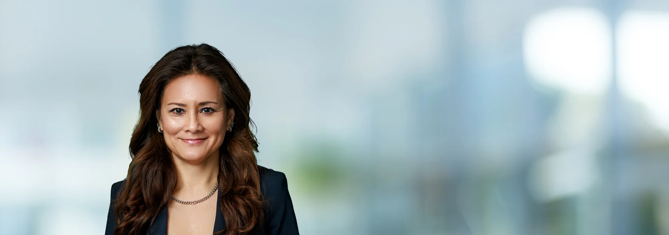 A photo of attorney, Kristine Phillips, against a softly blurred office background.