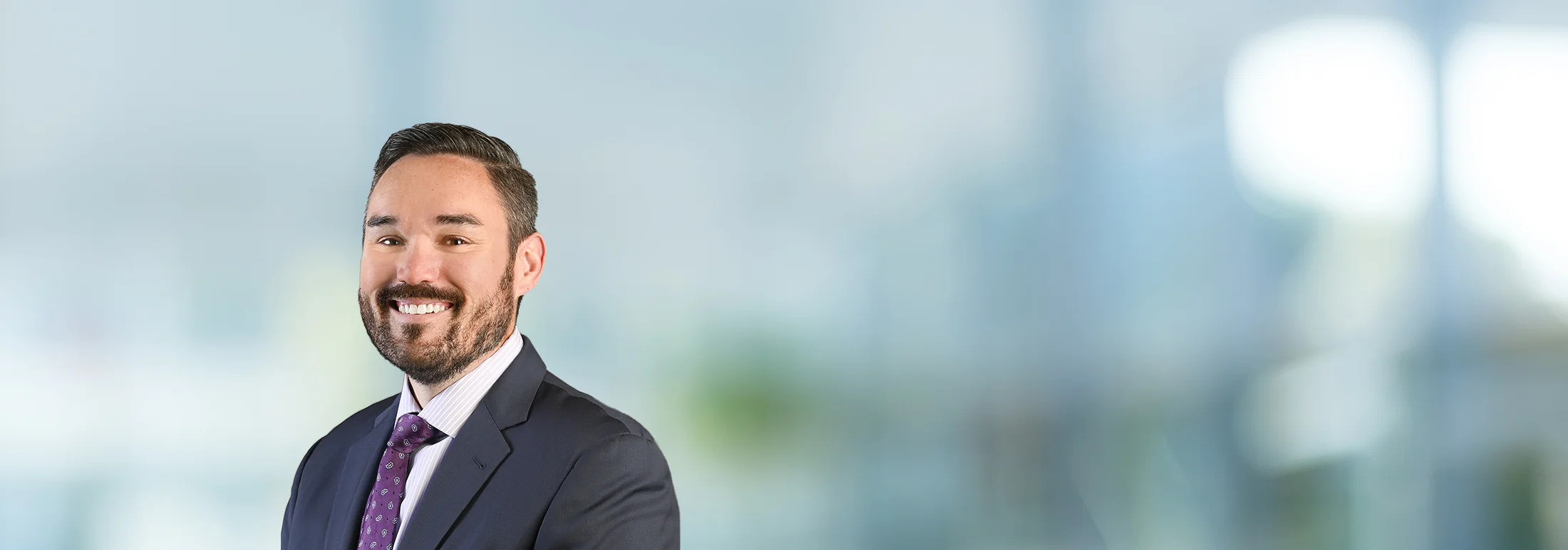 A photo of attorney, Sean Rohan, against a softly blurred office background.