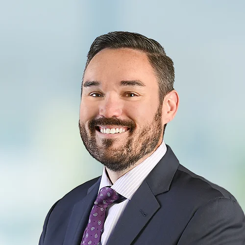 A photo of attorney, Sean Rohan, against a softly blurred office background.