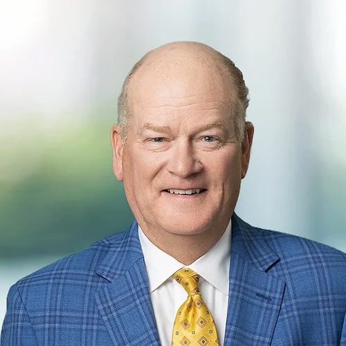 A photo of attorney, Luke Sheridan, against a softly blurred office background.