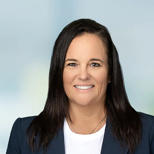 A photo of attorney, Denean Sturino, against a softly blurred office background.