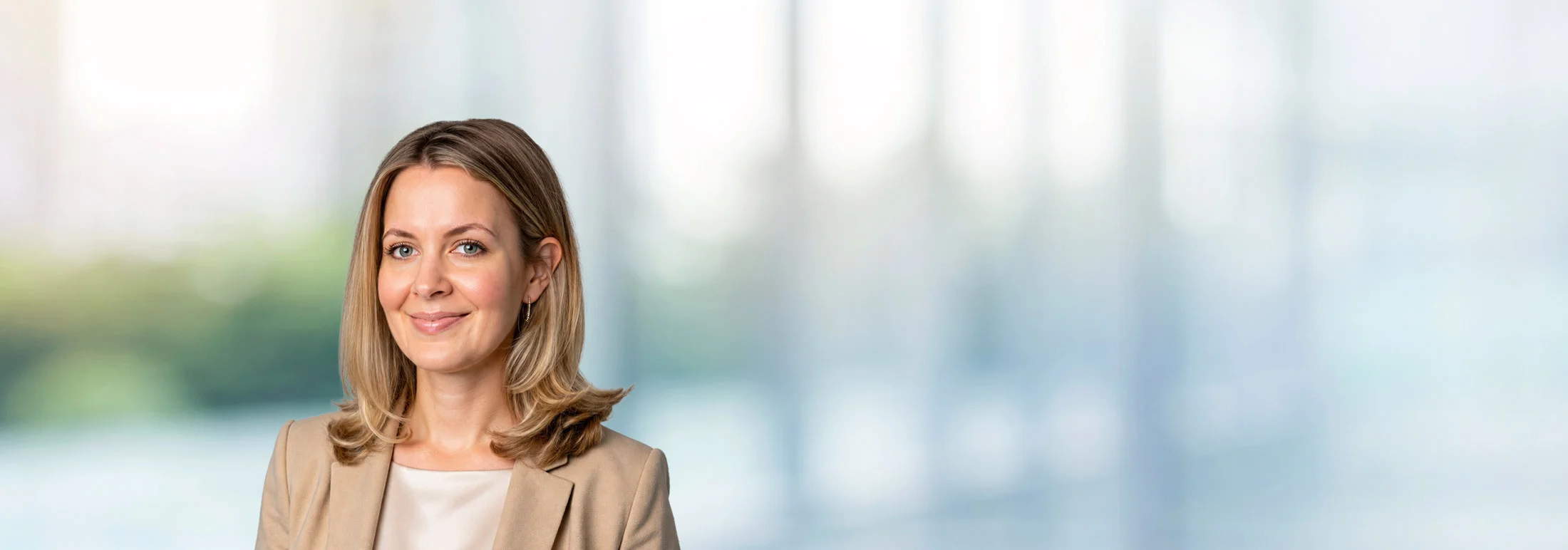 A photo of attorney Hilarie Carhill against a softly blurred office background