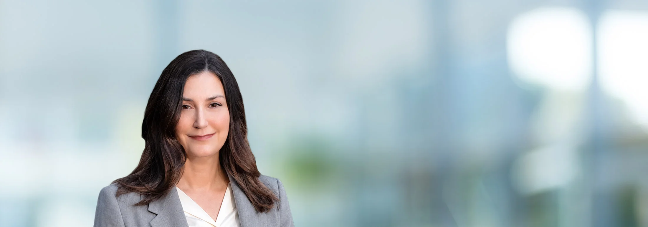A photo of attorney Kasey Myhra against a softly blurred office background