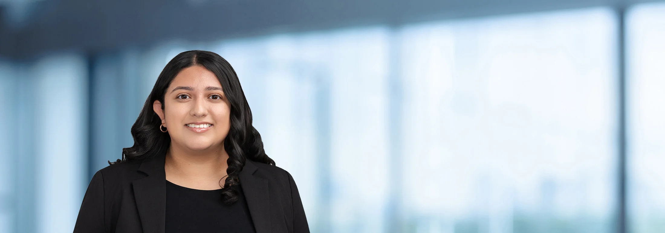 A photo of attorney Alyssa Castrillon against a softly blurred office background