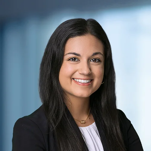 A photo of attorney, Niti Suchdev, against a softly blurred office background.