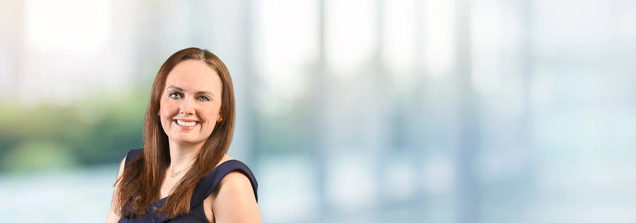 A photo of attorney, Amanda Walsh, against a softly blurred office background.