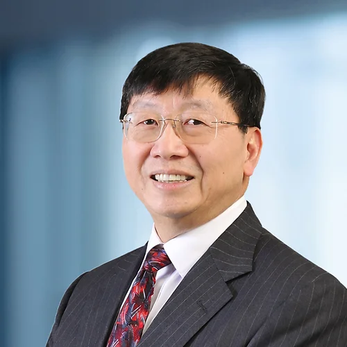 A photo of attorney, Jim Yong, against a softly blurred office background.
