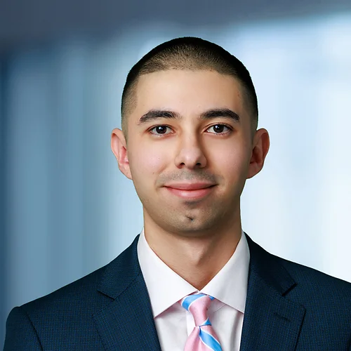 A photo of attorney, Antonio Zuniga, against a softly blurred office background.