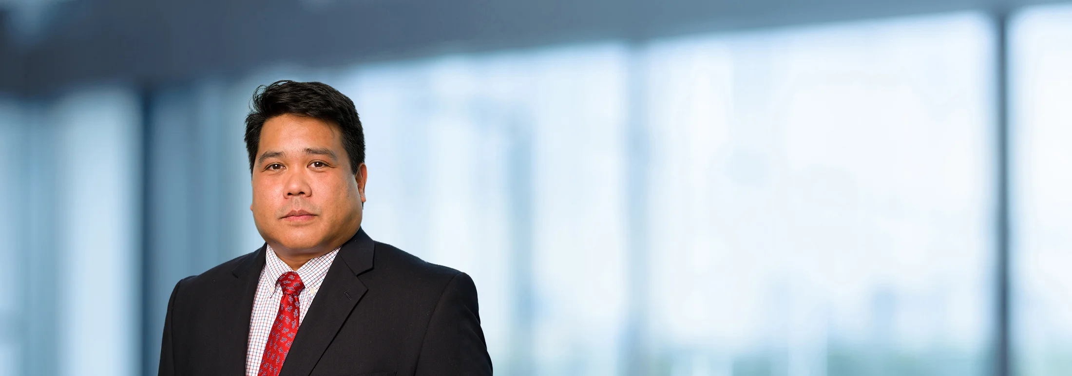 A photo of attorney, Ron Geronimo, against a softly blurred office background.