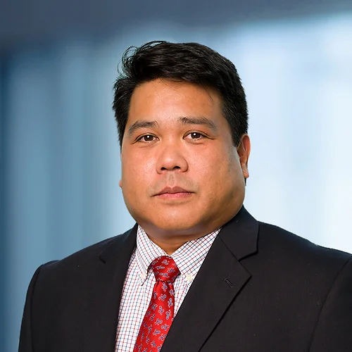 A photo of attorney, Ron Geronimo, against a softly blurred office background.
