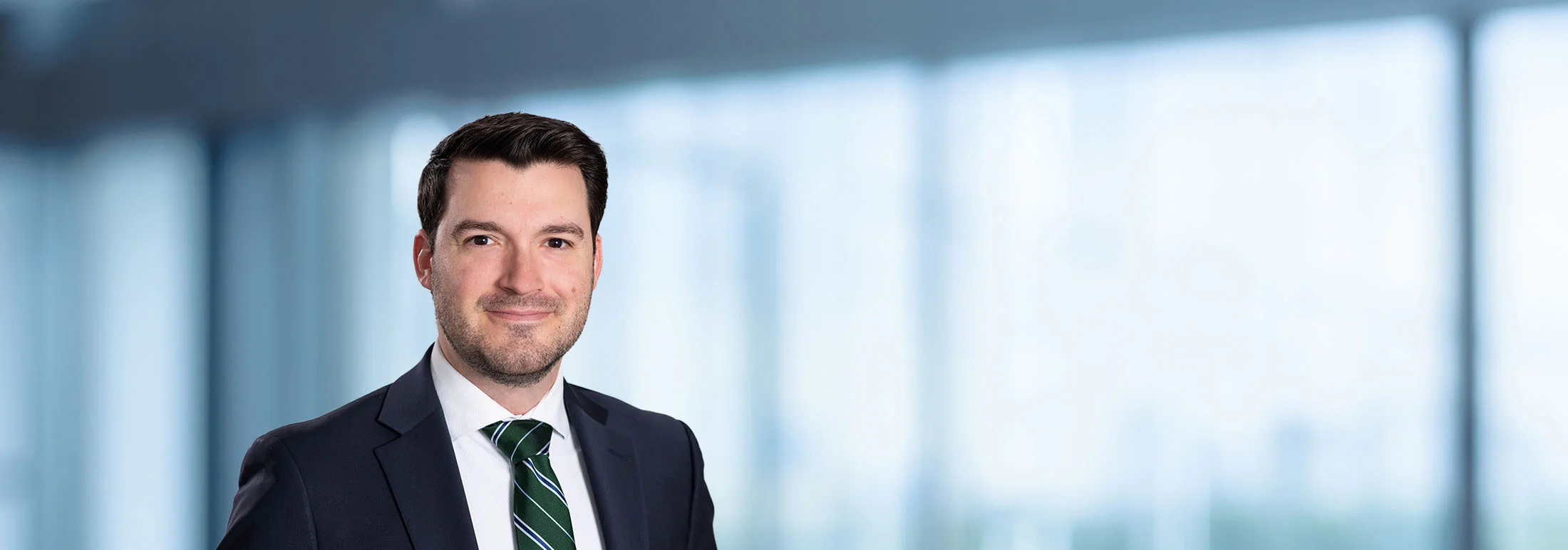 A photo of attorney, Brian DeMocker, against a softly blurred office background.