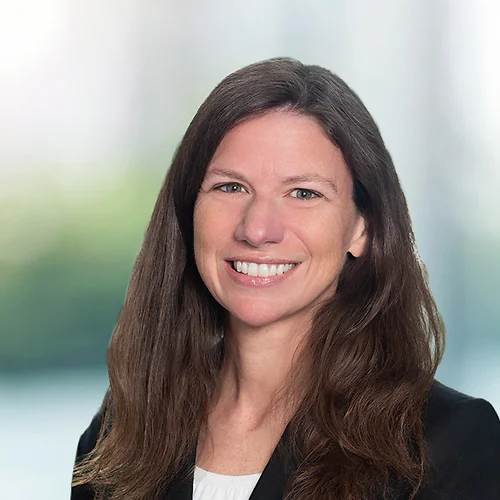 A photo of attorney, Meryl Mills, against a softly blurred office background.