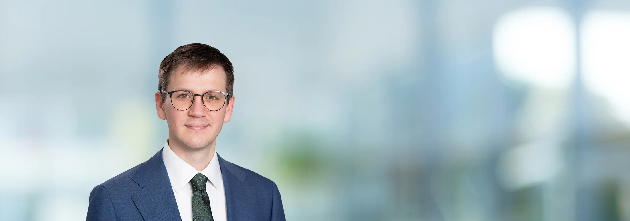 A photo of attorney, Garrett Respondek, against a softly blurred office background.