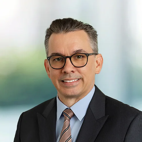A photo of attorney, Justin Twigg, against a softly blurred office background