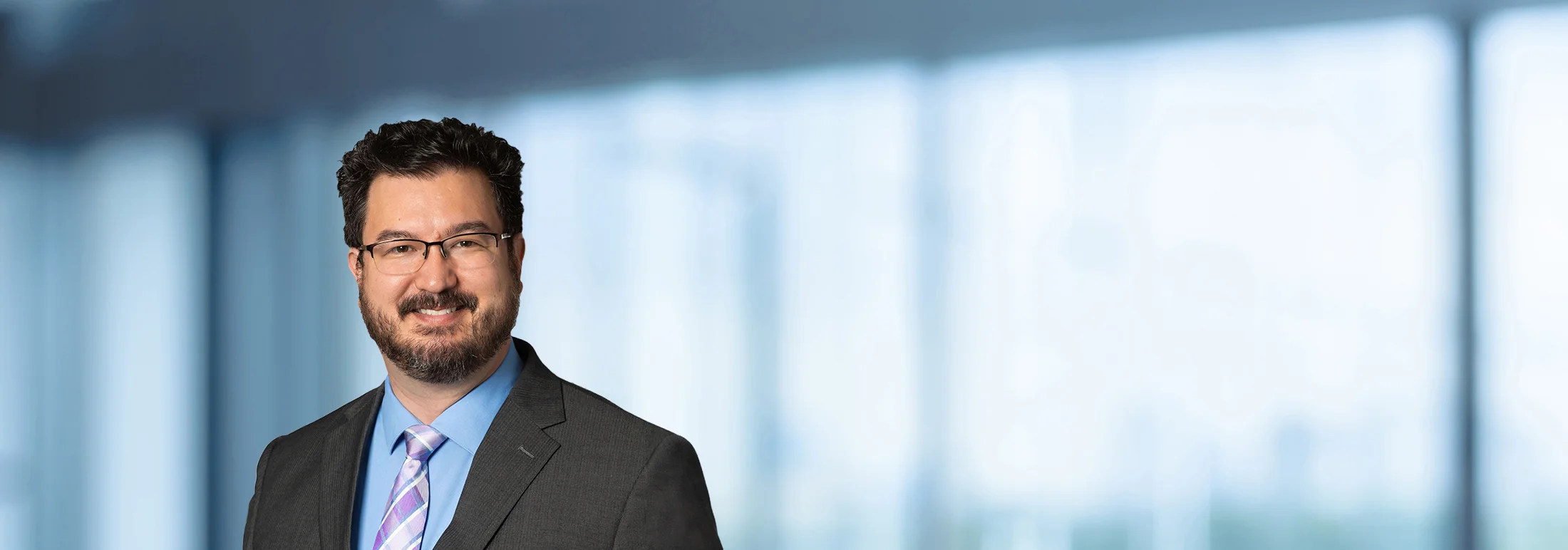 A photo of attorney, Kevin Cleveland, against a softly blurred office background