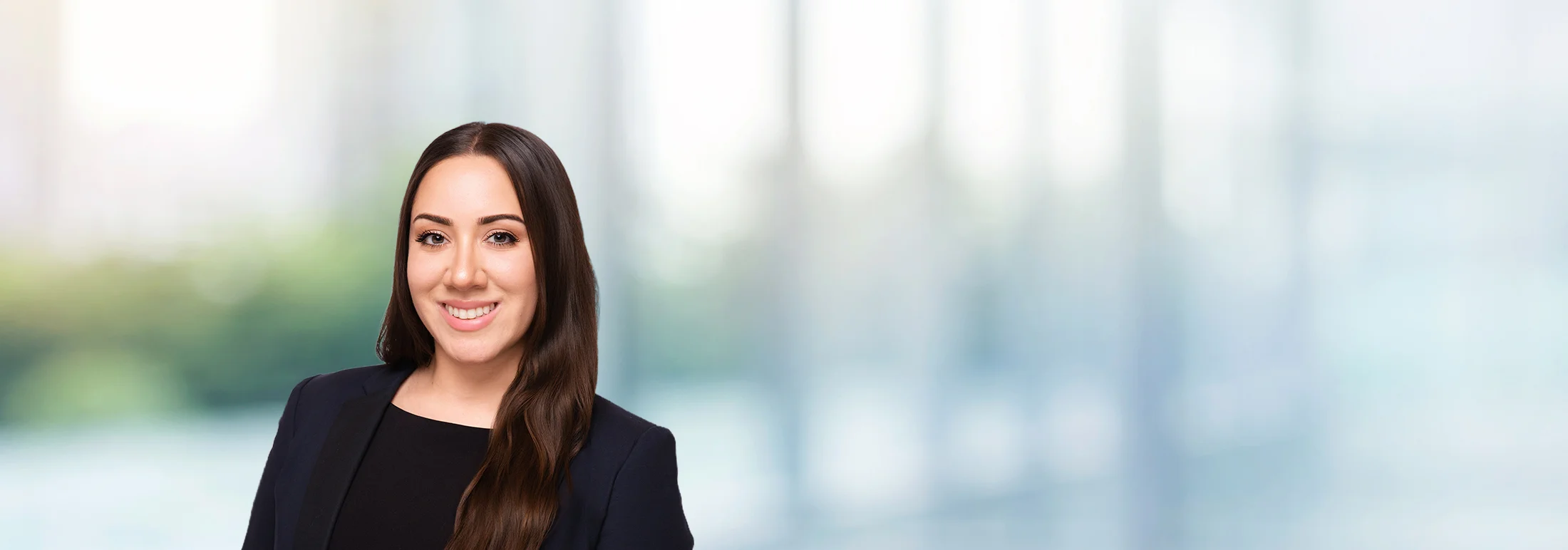 A photo of attorney, Andrea Cordova, against a softly blurred office background