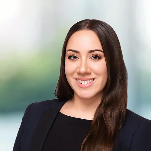 A photo of attorney, Andrea Cordova, against a softly blurred office background
