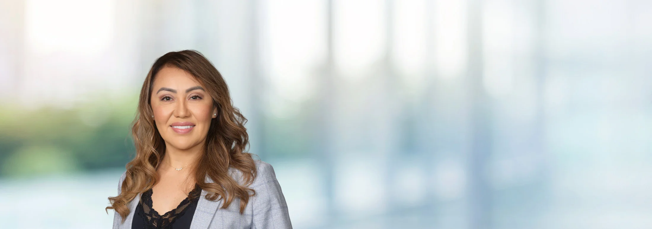 A photo of attorney, Susana Solano, against a softly blurred office background
