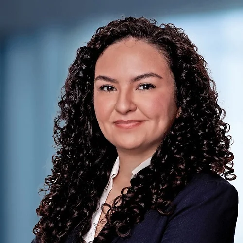 A photo of attorney, Alexis Arteaga, against a softly blurred office background